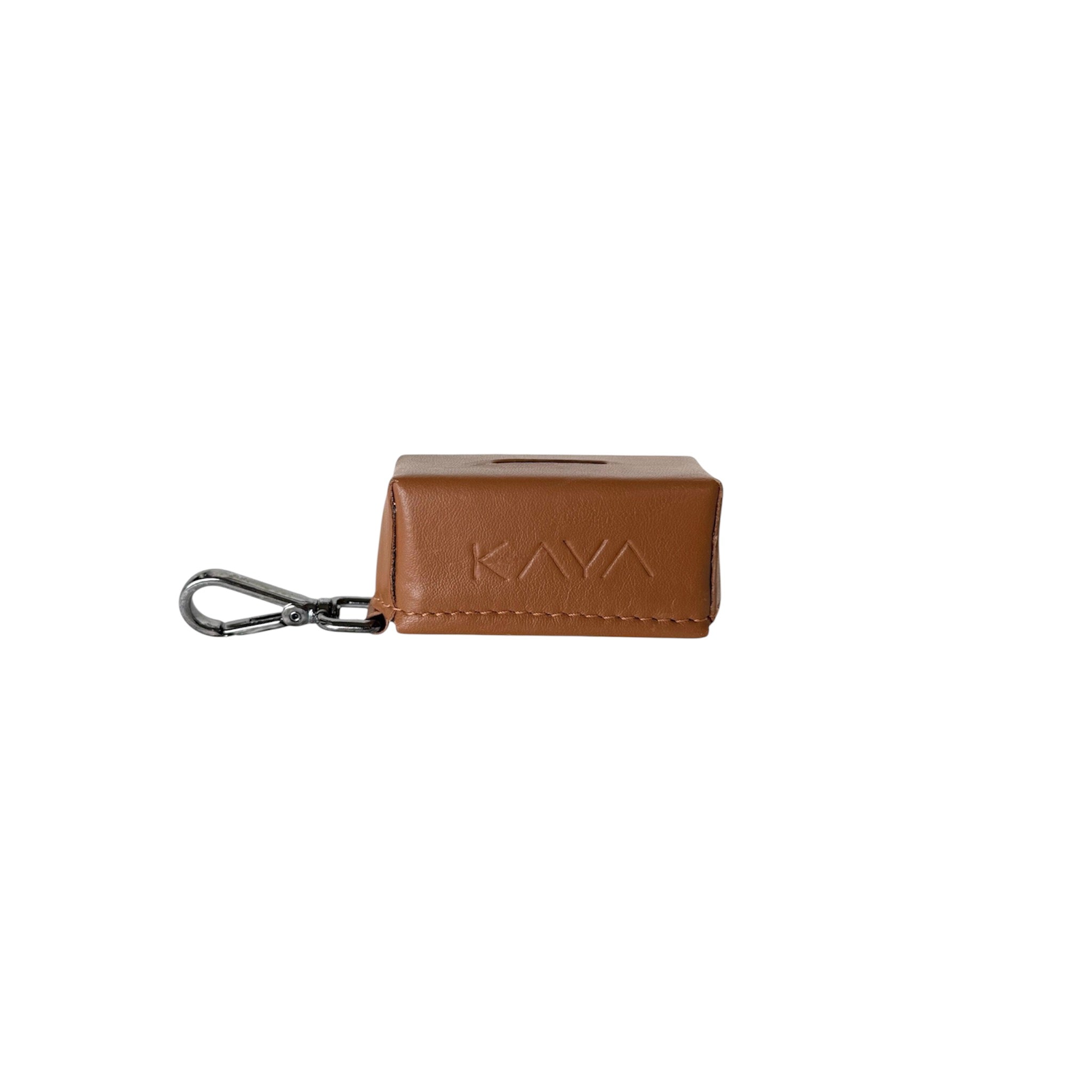 A caramel rectangular leather waste bag holder with the brand name 'KAVA' embossed on the front, attached to a silver metal carabiner clip, shown against a plain white background.